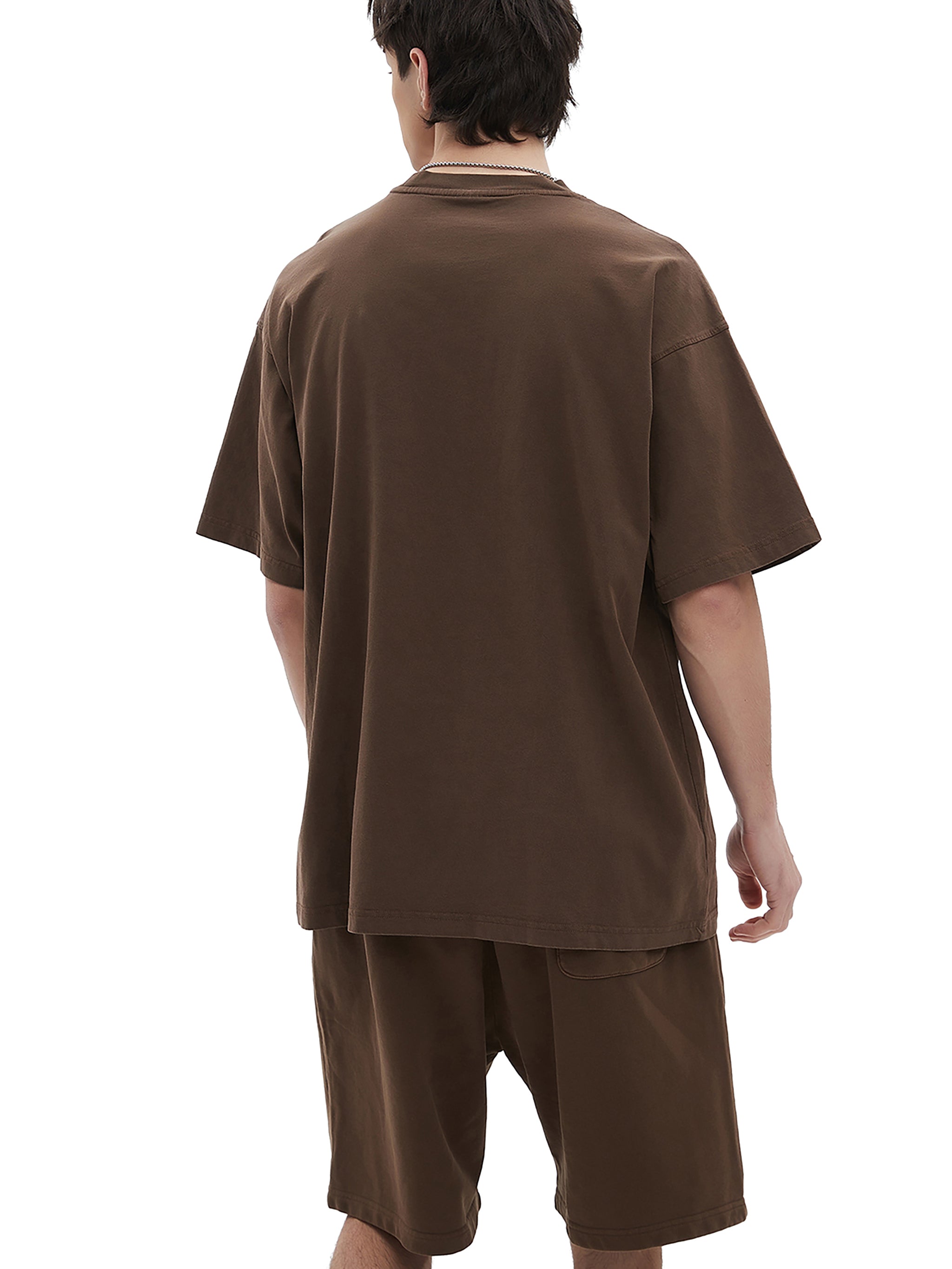 BLANKZ Enzyme-Washed Tee — Model wearing the tee, rear three-quarter view