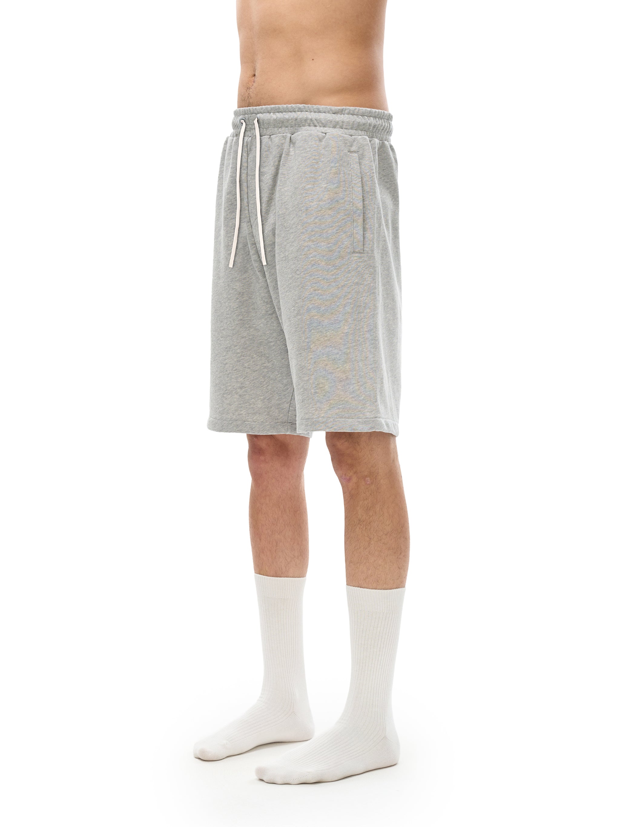 BLANKZ Essential Cotton Short — Model wearing the garment, front three-quarter view