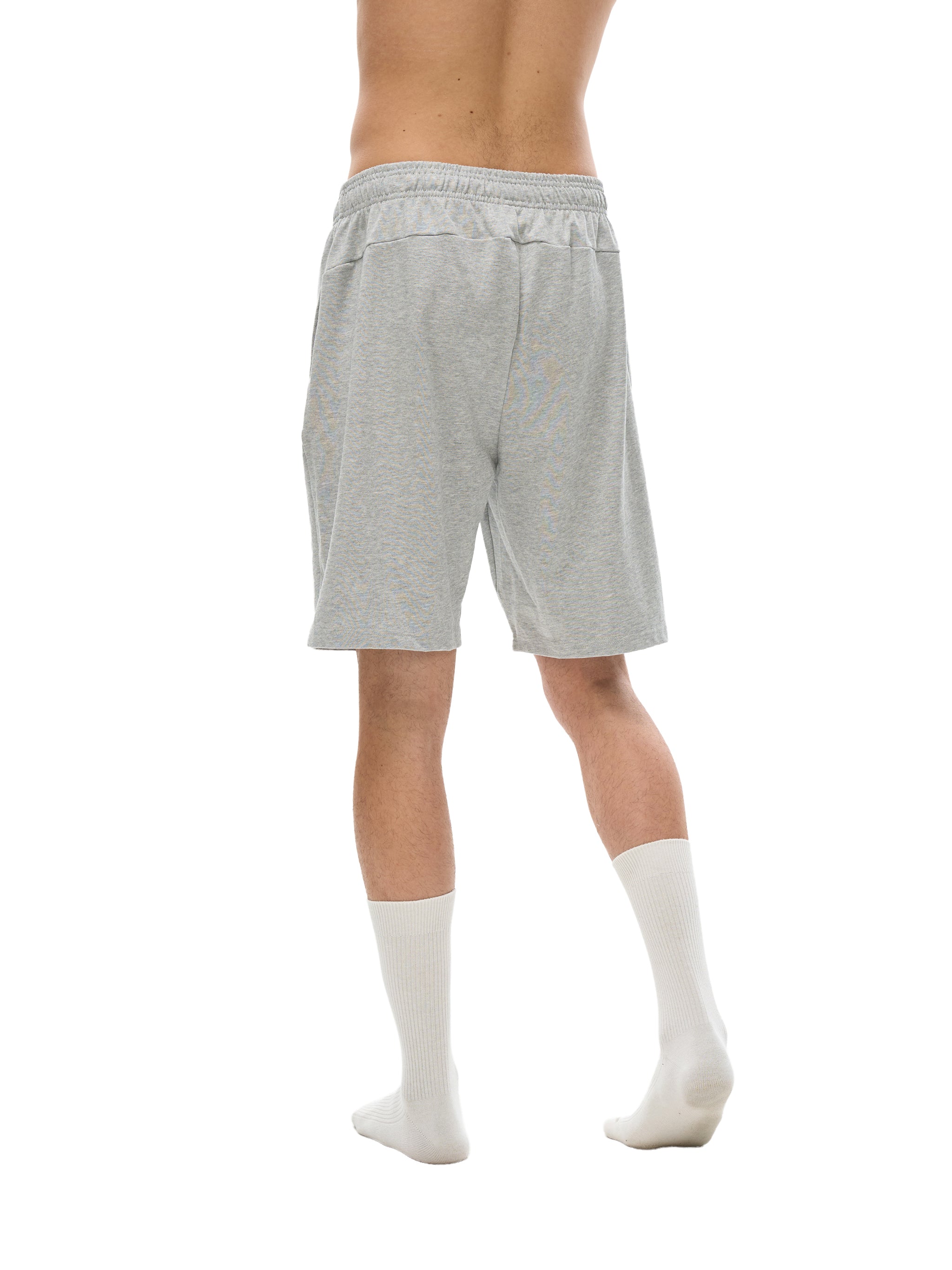 BLANKZ Essential Cotton Short — Model wearing the garment, rear three-quarter view