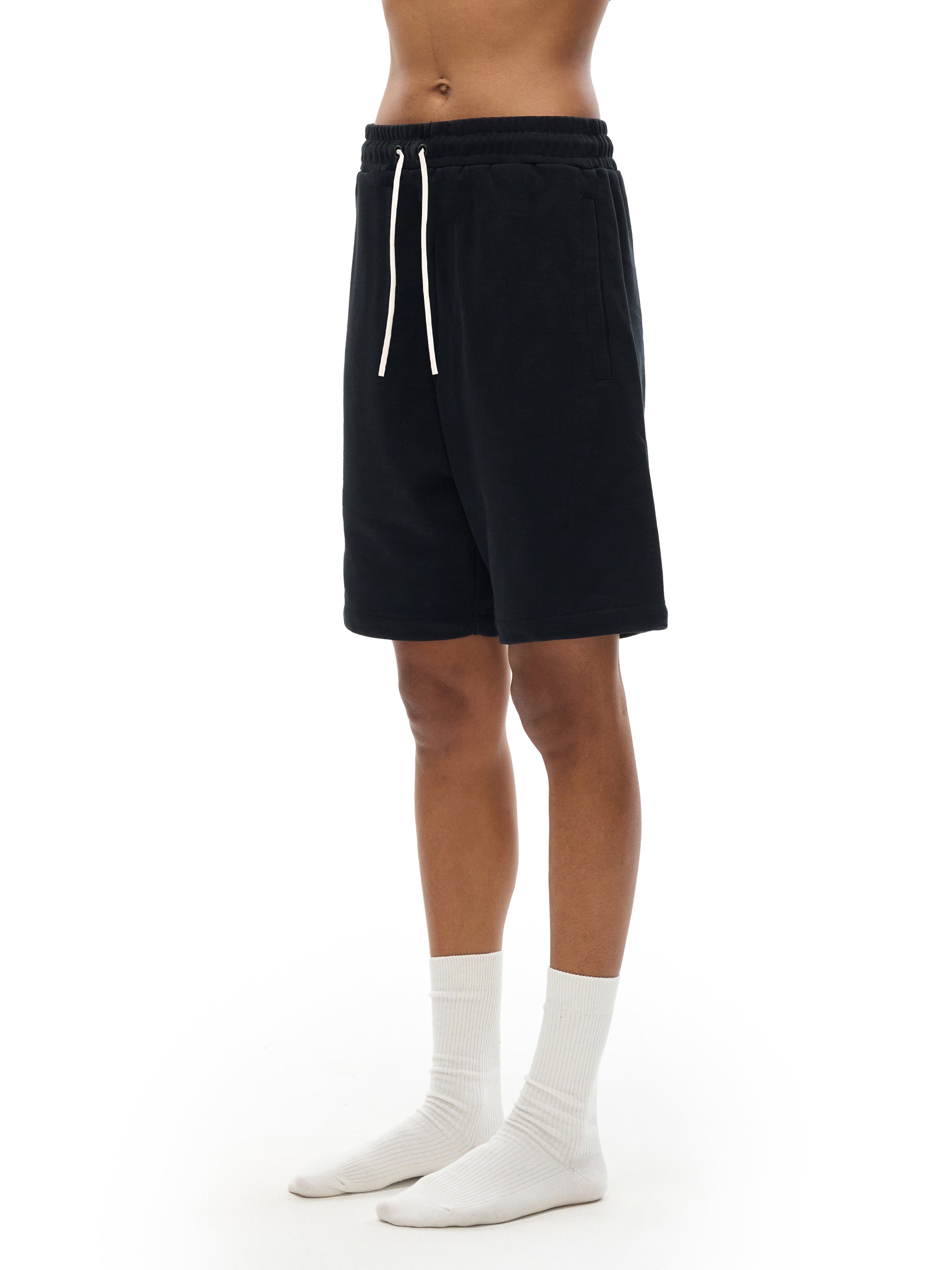 BLANKZ Essential Cotton Short — Model wearing the garment, front three-quarter view