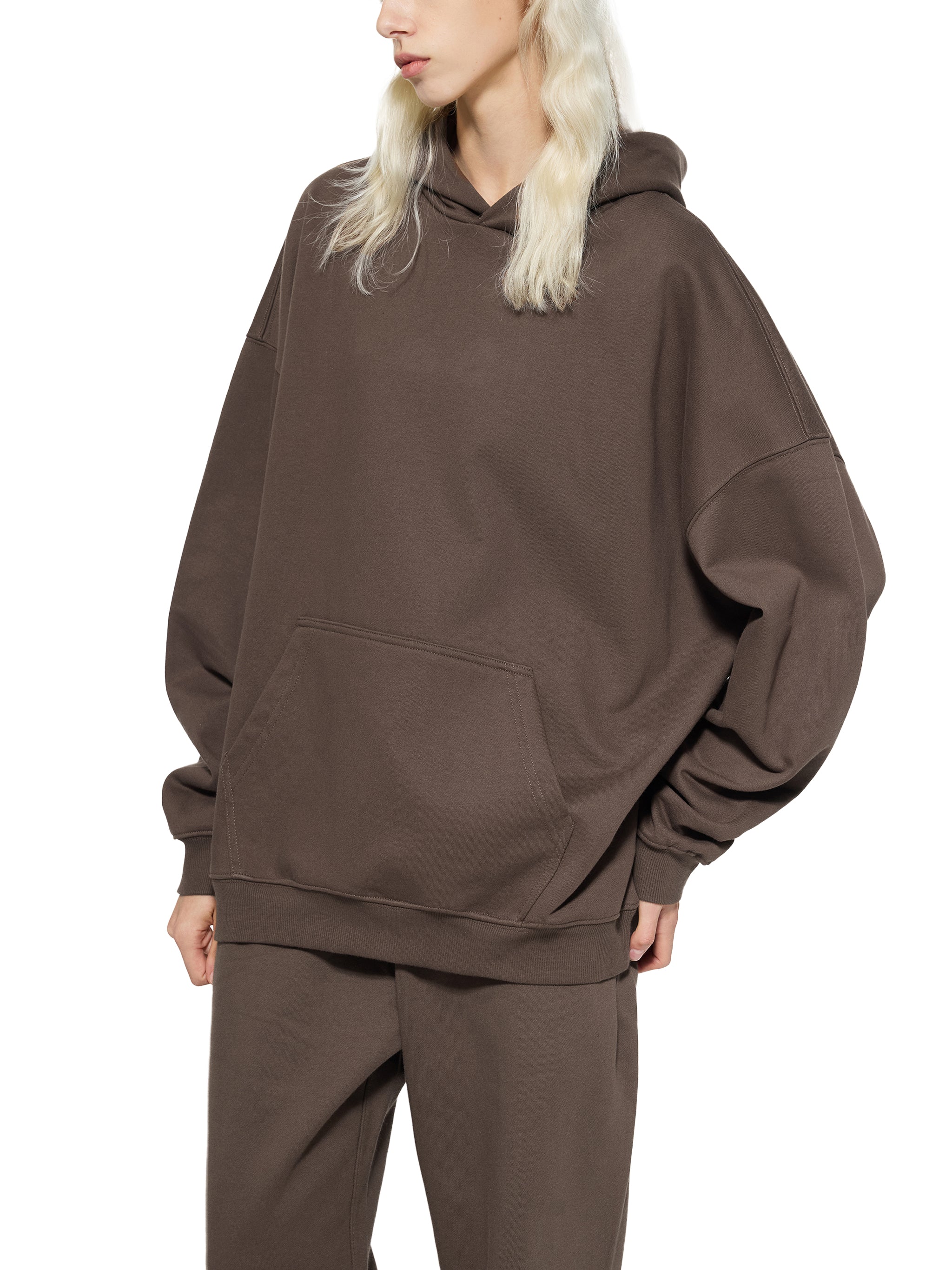 BLANKZ Essential Heavyweight Hoodie — Model wearing the garment, side view