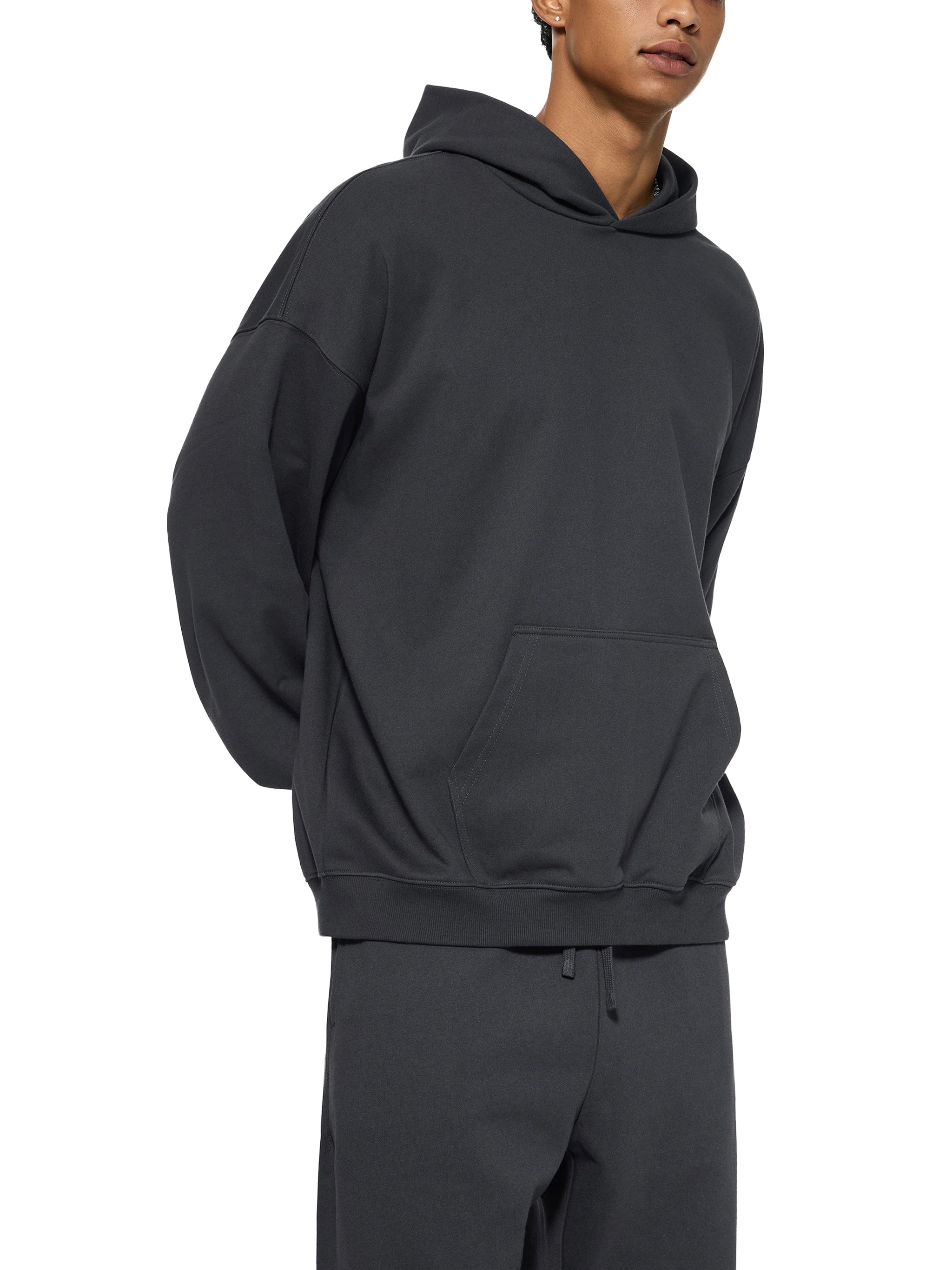 BLANKZ Essential Heavyweight Hoodie — Model wearing the garment, side view