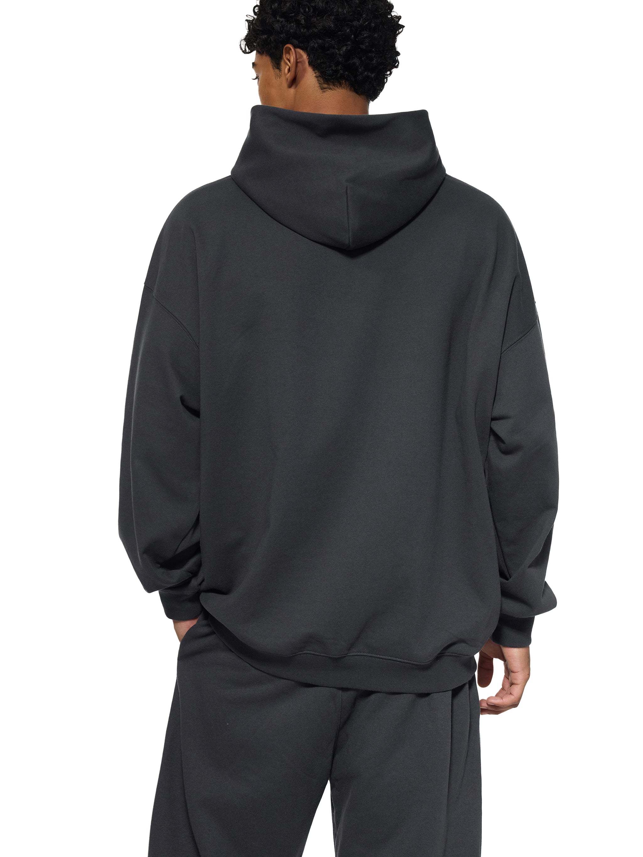 BLANKZ Essential Heavyweight Hoodie — Model wearing the garment, back view