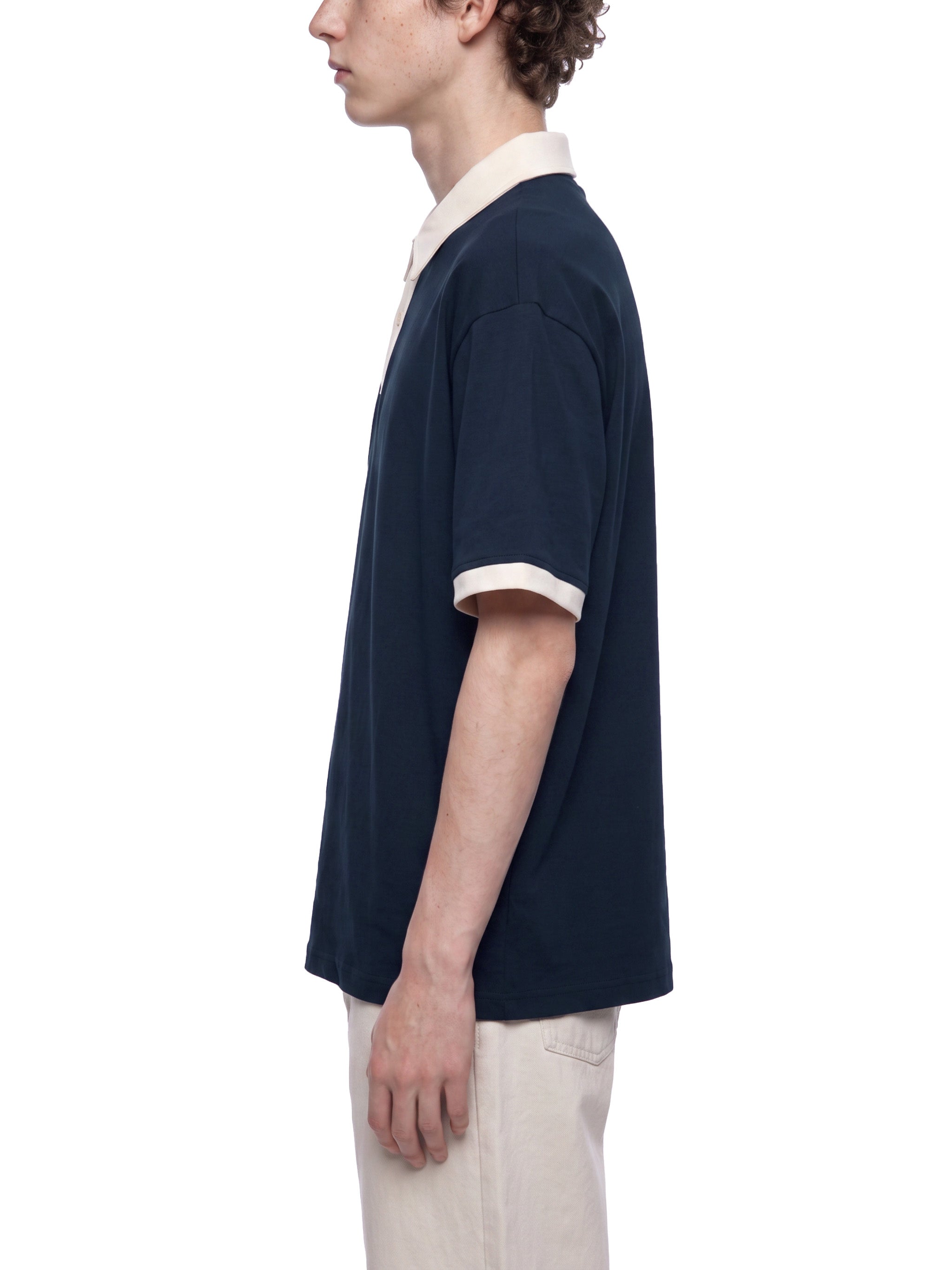 BLANKZ Color Block Polo Shirt — Navy Blue with Apricot — worn side view