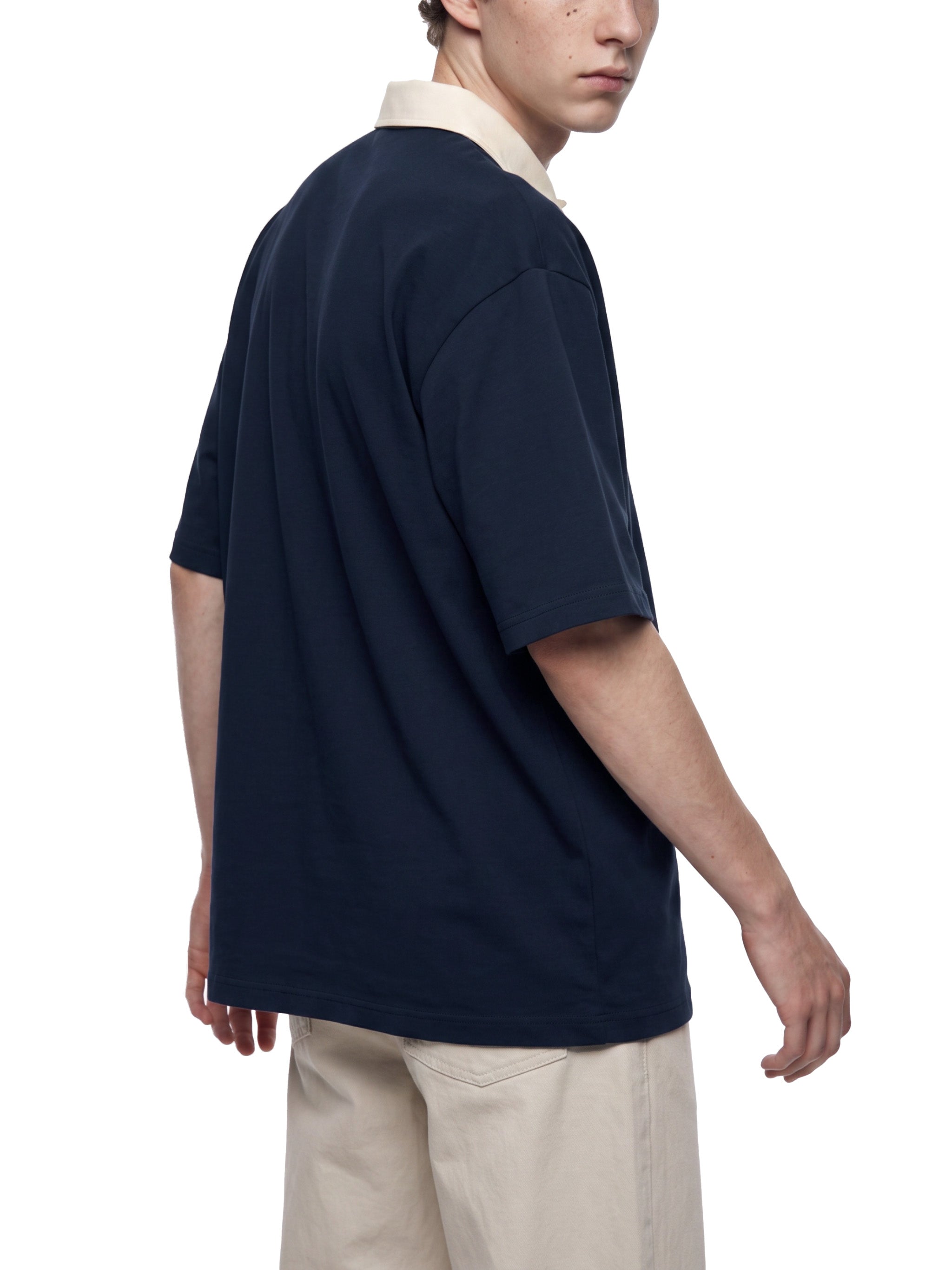 BLANKZ Color Block Polo Shirt — Navy Blue with Apricot — angled back view
