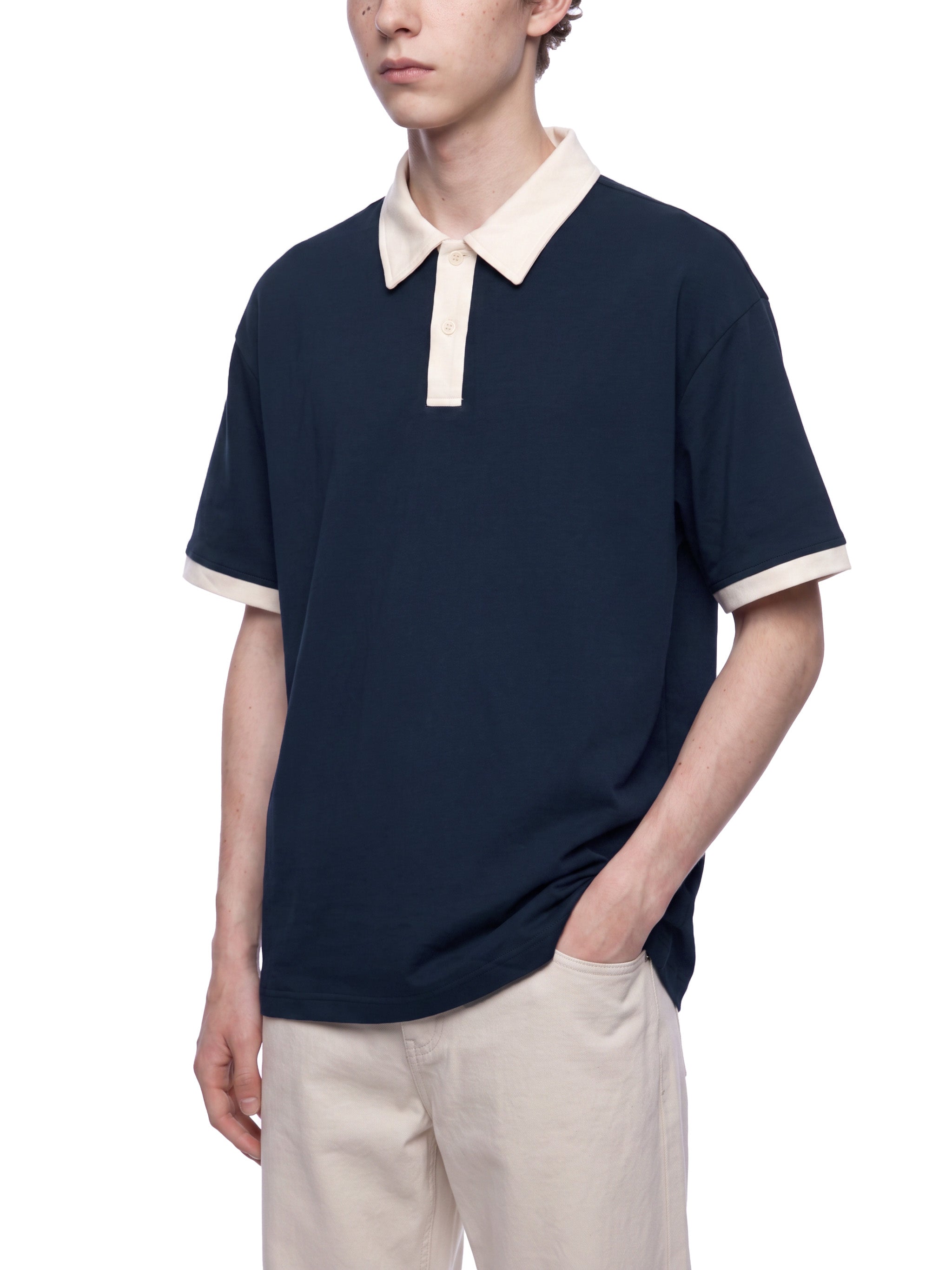 BLANKZ Color Block Polo Shirt — Navy Blue with Apricot — angled front view