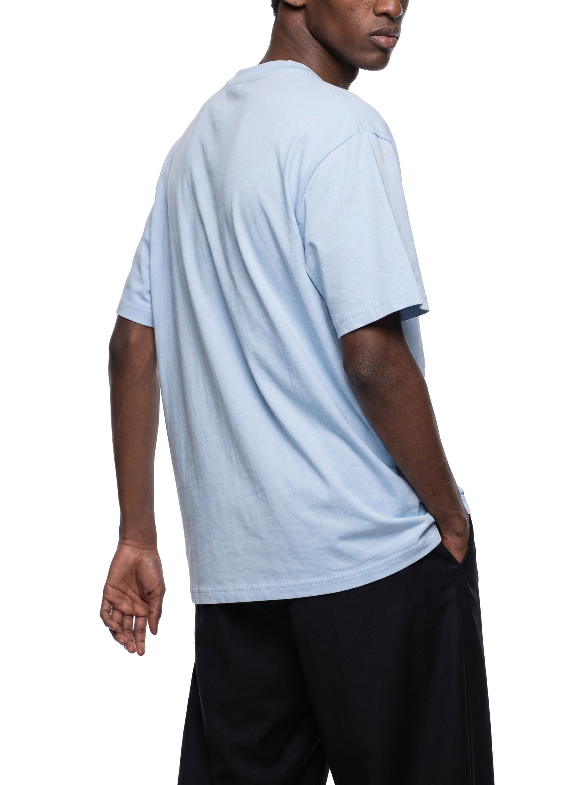 BLANKZ Everyday Cotton Tee — Model wearing the tee, rear three-quarter view
